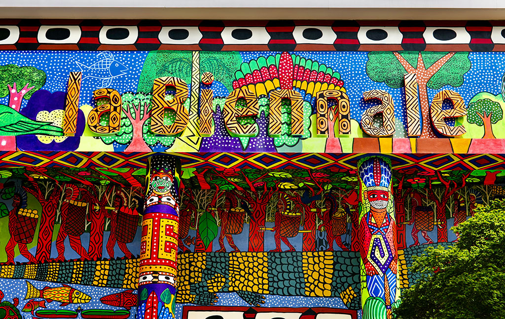 Colorful mural at the Venice Biennale showcasing intricate patterns and vibrant illustrations with "la Biennale" written across the top.